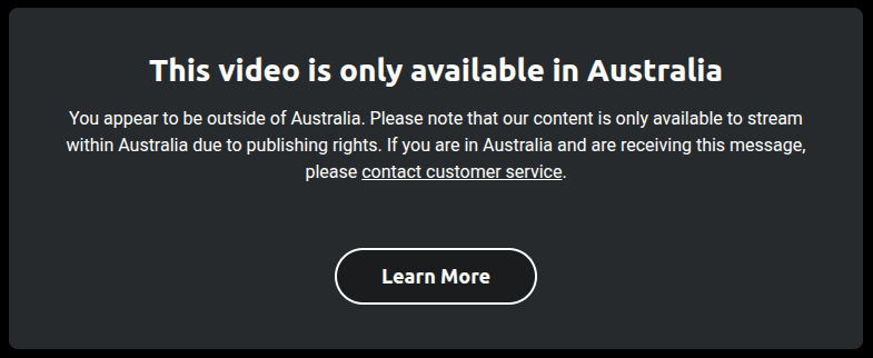 A message box with white text stating, "This video is only available in Australia" with details on streaming rights and a "Learn More" button below.